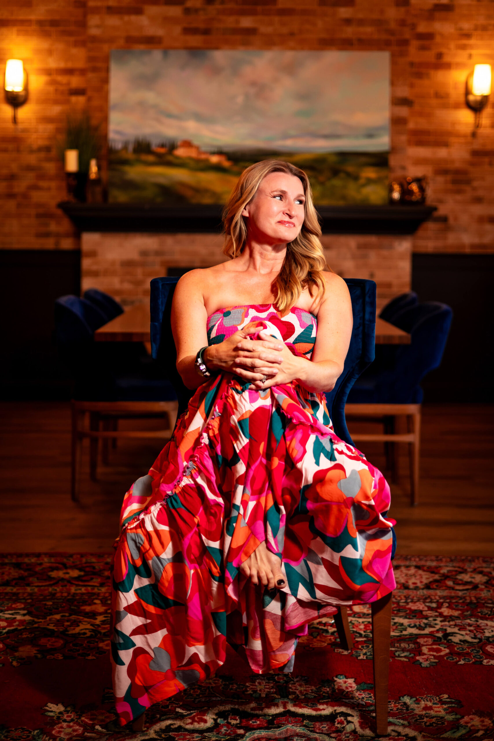 Vibrant female entrepreneur wearing a colorful dress during a branding photoshoot.