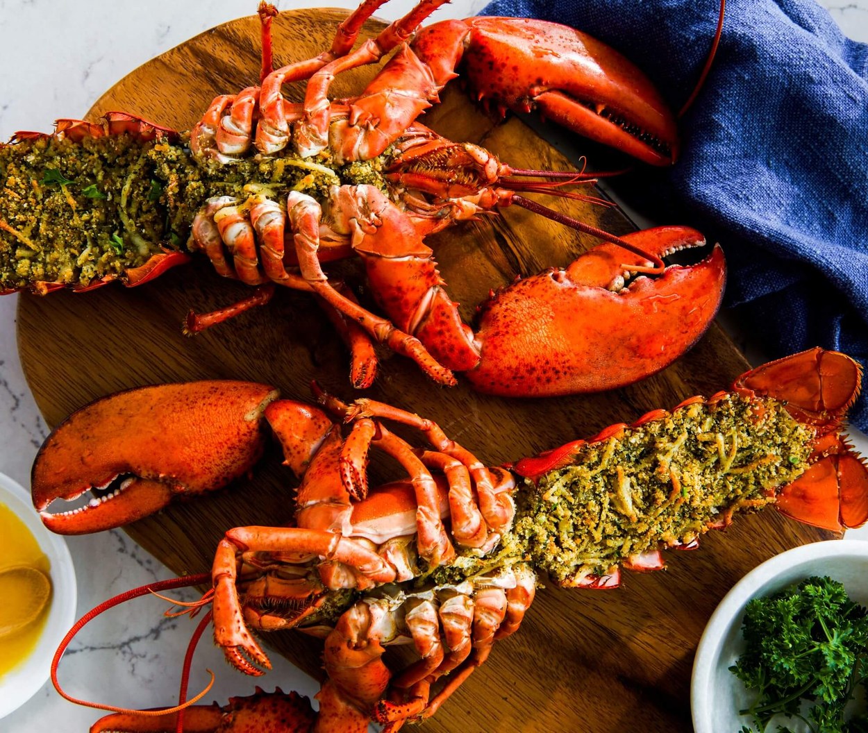 Lobster PEI Photography Grilled PEI lobster tails with herb butter on a wooden board