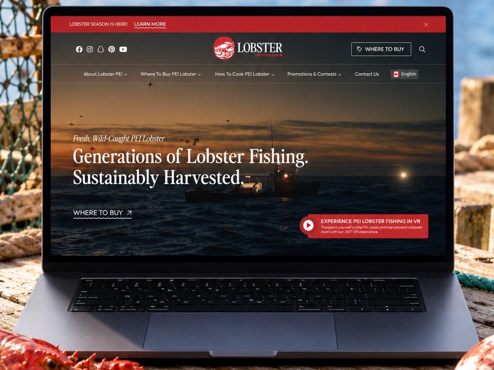 Lobster PEI Website Laptop Lobster PEI website homepage on a laptop on a weathered wharf beside fresh lobster, rope and fishing boats